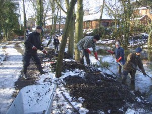 Removing last autumn’s leaves and fallen branches from the pond